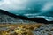 Rainy cloudscape over a rocky landscape view