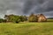 Rainy day in the countryside. Dramatic sky. Overcast sky over an old barn. Pastures in the Czech Republic