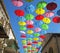 Rainy day protection with flying umbrellas in a summer street festival