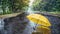 On a rainy day, a yellow umbrella was lying in the middle of a deserted road. An ominous image. Generative AI.