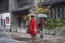 On rainy days, two tourists with umbrellas walked through the scenic spot, one of them wearing a red ancient robe