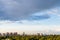 Rainy gray cloud in blue evening sky over city