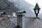 Rainy moody autumn weather outdoor garden scenic view of vintage house with shingle roof and chimney in gray October day