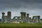 A rainy morning at the Stonehenge prehistoric site with dark clouds