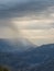 Rainy mountain natural background. Dramatic sky on mountain peaks. Mystical background with dramatic mountains. Rain in mountains