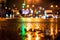 Rainy night in the big city, pedestrians cross the busy intersection.