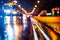 Rainy night in the big city, stream of cars traveling along the avenue.