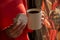 Rainy and sunny day environment. Woman hands holding alfajor with powdered sugar and cup of coffee next to the window.