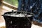 Rainy weather on the terrace in summer. The rain falls into the bucket and creates splashes.