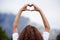 Raise your level of love. Rearview shot of an unrecognizable young woman out for an early morning hike in the mountains.