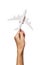 A raised female hand holds an airplane isolated