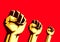 Raised fists in the air on the red background, protest concept. A fight against social inequality and racism. Defense of