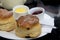 Raisin scones with jam and clotted cream on white plate