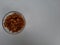 Raisins in a bowl on a plain white background.