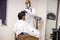 Rajasthan, india, April 24th 2020: A professional hairdresser wearing mask and gloves cutting hair to a client, Salon and