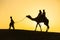 Rajasthan travel background - camel silhouette in dunes of Thar desert on sunset