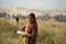 Rajasthani girl collecting camel stool to use these as fuel at home.