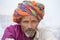 Rajasthani tribal man wearing traditional colorful turban attends the annual Pushkar Cattle Fair, Pushkar, Rajasthan, India