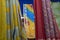 Rajasthani womens clothes are hanging for sale, being displayed in a shop at famous Sardar Market and Ghanta ghar Clock tower in