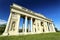 Rajstna colonnade in the middle of the grass field in strong perspective