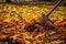 Rake And Pile Of Fallen Leaves On The Lawn In Autumn Park. Generative AI