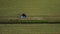 Raking hay with a double wheel rake tractor on a sunny day aerial view