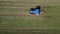 Raking hay with a double wheel rake tractor on a sunny day aerial view