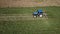 Raking hay with a double wheel rake tractor on a sunny day aerial view