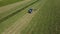 Raking hay with a double wheel rake tractor on a sunny day aerial view