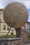 Rakovnik, Czech Republic - July 2, 2022 - the statue of a man rolls a heavy stone up the mountainside on a sunny summer afternoon