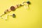 Raksha Bandhan, Indian festival with beautiful Rakhi and  Rice Grains on yellow background.  A traditional Indian wrist band which