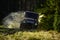 Rallying, competition and four wheel drive concept. Motor racing in autumn forest. Sport utility vehicle or SUV crossing