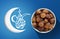 Ramadan Fasting Dates with Crescent over Blue