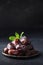 Ramadan. Iftar starts. Dates in bowl garnish mint on black background. Close up. Vertical format