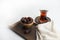 Ramadan Kareem Festival, Dates on wooden bowl with cup of black tea and rosary on white  background