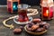 Ramadan Kareem Festive, close up of dates on wooden plate and rosary with oriental Lantern lamps and cup of black tea on wood