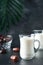 Ramadan Kareem food and drinks. Plate of dates, glass of milk and date palm branch on black background. Righteous Muslim Lifestyle