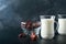 Ramadan Kareem food and drinks. Plate of dates, glass of milk and date palm branch on black background. Righteous Muslim Lifestyle