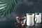 Ramadan Kareem food and drinks. Plate of dates, glass of milk and date palm branch on black background. Righteous Muslim Lifestyle