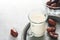 Ramadan Kareem food and drinks. Plate of dates, glass of milk and date palm branch on light grey background. Righteous Muslim