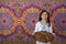 Ramadan Kareem - Happy young Muslim girl presenting a tray of Arabian dates for iftar