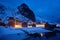 Ramberg village with red traditional rorbue houses in the night, Norway