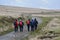 Ramblers walking the granite path on Dartmoor National Park, Devon, UK