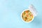 Ramen cup, instant noodles in a plastic cup, overhead shot on a blue background