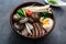 Ramen noodles bowl with egg, enoki, shiitake mushrooms, duck and onion