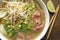 Ramen soup with noodle with meat, fresh herbs and vegetables