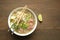 Ramen soup with noodle with meat, fresh herbs and vegetables