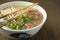 Ramen soup with noodle with meat, fresh herbs and vegetables
