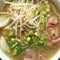 Ramen soup with noodle with meat, fresh herbs and vegetables