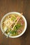 Ramen soup with noodle with meat, fresh herbs and vegetables